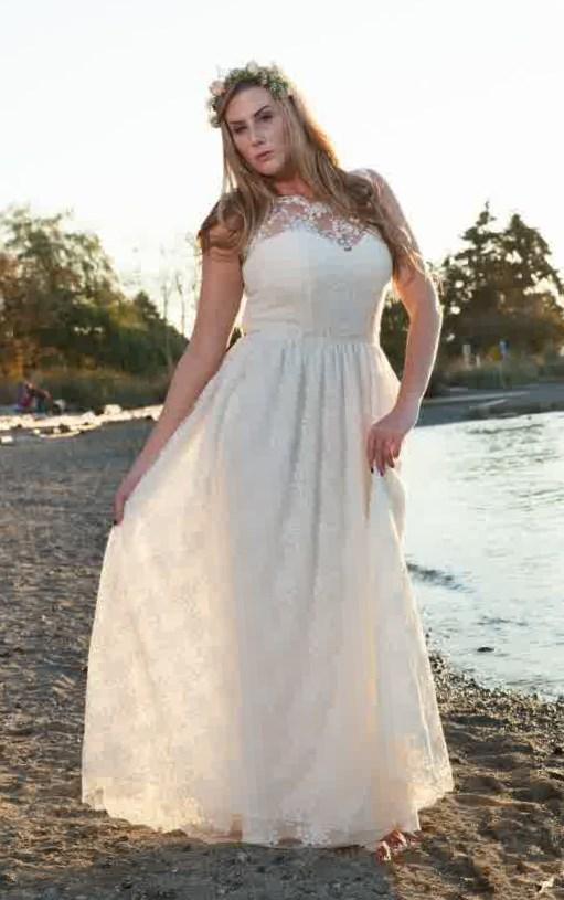 A plus size bride in a beach wedding dress with stunning details